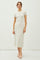 woman wearing a cream short sleeve midi dress with a fitted silhouette and a round neckline
