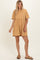 woman wearing a mustard yellow short sleeve babydoll dress with a relaxed fit and round neckline