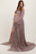 woman wearing a dusty mauve lace maternity gown with bell sleeves and a thigh-high slit, showcasing her baby bump