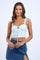 woman wearing a light blue floral crop top with adjustable ties and ruffled straps