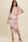 woman wearing a long sleeve pastel marble print midi dress and pink heeled sandals