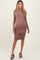 woman wearing a long sleeve taupe maternity dress with side ruching, showcasing her baby bump