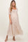 woman wearing a light floral maternity dress with short puff sleeves and a flowing silhouette
