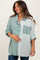 woman wearing a maternity green and white striped oversized button-up shirt and holding her baby bump