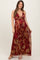 woman wearing a burgundy floral maternity maxi dress with a deep v-neck and empire waist, showcasing her baby bump