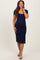 woman wearing a navy blue short sleeve maternity dress with a fitted silhouette and scoop neckline, showing her baby bump