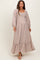 woman wearing a floral print maternity maxi dress with long sleeves and a smocked bodice, showcasing a baby bump