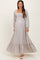 woman wearing a light purple floral maternity maxi dress with long sleeves and a smocked bodice, showing her baby bump