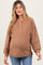 woman wearing a brown ribbed maternity sweater with a button-up neckline and a visible baby bump