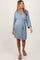 woman wearing a light blue maternity robe with a tie waist and kimono sleeves, showcasing her baby bump