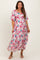 woman wearing a floral pink and blue maternity dress with short puff sleeves and a flowy silhouette, showing her baby bump