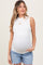 woman wearing a white sleeveless maternity top and denim shorts, showing her baby bump