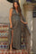 woman wearing a green button-up maternity maxi dress, standing on stairs with a visible baby bump