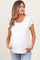 woman wearing a white short sleeve maternity top with a pocket and holding her baby bump