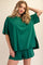 woman wearing a green oversized t-shirt and matching shorts with side slits