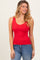 woman wearing a red fitted tank top with a scoop neckline paired with blue jeans