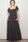 woman wearing a black floral print maxi dress with short puff sleeves and side pockets