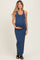 woman wearing a navy blue maternity maxi dress and holding her baby bump