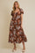 woman wearing a brown floral maxi dress with short puff sleeves and a tiered skirt