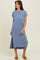 woman wearing a light blue striped midi dress with cap sleeves and a side slit