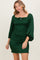 woman wearing a dark green smocked mini dress with puff sleeves and a square neckline