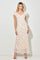 woman wearing a cream floral maxi dress with short puff sleeves and a v-neckline