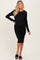 woman wearing a black ribbed maternity dress with a fitted silhouette and long sleeves, showing her baby bump