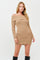 woman wearing a tan ribbed off-the-shoulder long sleeve sweater dress