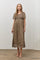 woman wearing a brown floral embroidered maxi dress with short sleeves and a smocked bodice.