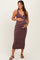 woman wearing a burgundy and white striped maternity maxi dress while holding her baby bump