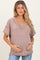 woman wearing a mauve ribbed v-neck maternity top and holding her baby bump