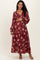 woman wearing a burgundy floral maxi maternity dress and holding her baby bump