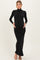 woman wearing a black long sleeve maternity dress, holding her baby bump