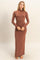 woman wearing a brown long sleeve maxi dress with a high neckline