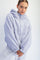 woman wearing a lilac fleece hoodie with a half-zip and oversized fit, styled with grey sweatpants