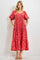 woman wearing a red floral midi dress with puff sleeves and pockets
