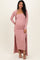 woman wearing a pink ribbed maternity dress with a long cardigan and showing her baby bump