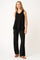 woman wearing a black sleeveless top and black wide-leg pants with a relaxed fit