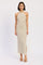 woman wearing a beige striped halter neck maxi dress with side slits
