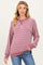 woman wearing a burgundy and white striped maternity sweatshirt with a relaxed fit and long sleeves