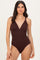 woman wearing a dark brown ribbed one-piece swimsuit with a deep v-neckline and adjustable straps