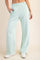 woman wearing mint green wide leg sweatpants with side pockets and an elastic waistband
