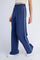 woman wearing navy blue wide-leg pants with a white side stripe and an elastic waistband