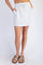 woman wearing a light gray casual mini skirt with side pockets and drawstring waist, paired with brown slide sandals