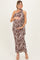 woman wearing a brown and cream floral print maternity dress with a halter neck, holding her baby bump