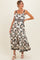 woman wearing a floral print maternity maxi dress with a fitted bodice and tiered skirt, showing her baby bump