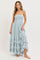 woman wearing a light blue strapless maxi dress with a smocked bodice and ruffled hem