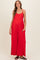 woman wearing a red maternity jumpsuit with a relaxed fit and pockets, showcasing her baby bump