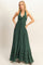 woman wearing a dark green halter neck maxi dress with a smocked bodice and tiered ruffle hem