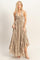 woman wearing a taupe halter neck maxi dress with a tied front and ruffle hem